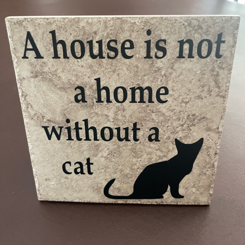 A house is not a home without a cat. Grey stone tile with heartwarming message.